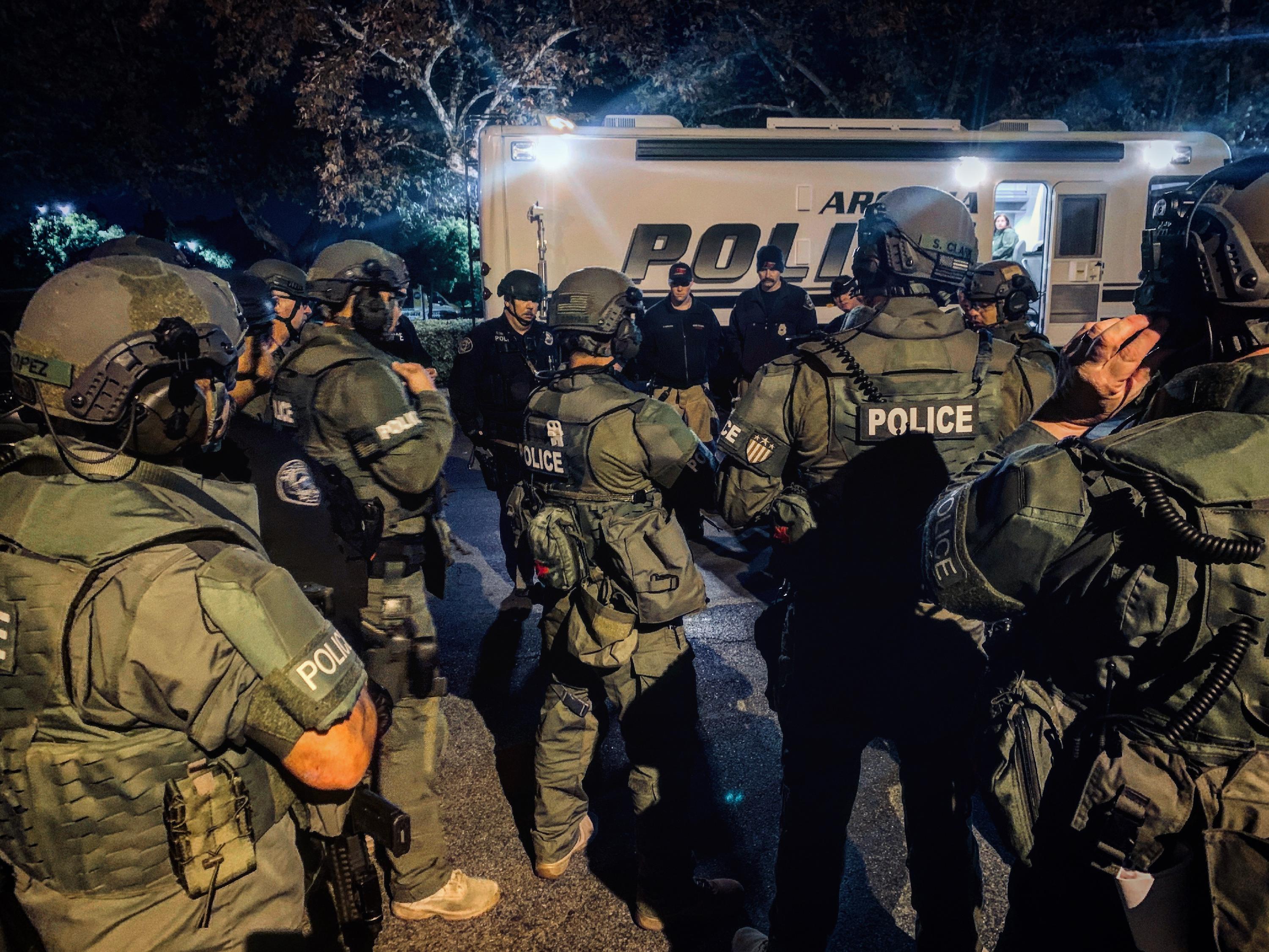 SWAT officers in uniform prepping for assignment